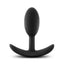 A black silicone butt plug stands against a white backdrop with a rounded tip.