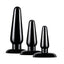 A trio of black PVC anal plugs stand against a white backdrop with tapered rounded tips.