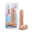 A package by Blush stands against a white backdrop next to a realistic dildo with balls.