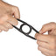 A hand model pulls at either side of a black liquid silicone cock ring to showcase its stretchiness. 