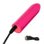 A mini pink bullet vibrator lays flat and showcases its charging cord attached to the base.