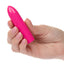 A hand model holds a classic pink bullet vibrator to showcase its size.