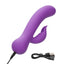 A purple turbo rabbit vibrator lays flat and showcases its charging cord connected to the base.