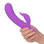 A hand model holds a purple turbo rabbit vibrator to showcase its size.