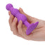 A hand model holds a purple vibrating triple beaded anal probe showcasing its size.