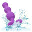 A purple triple beaded anal probe is shown splashing in water to showcase its waterproof properties.