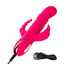 A pink triple fantasy rabbit vibrator lays flat on its side and showcases its charging cord attached to the base handle.