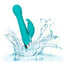 An aqua thrusting rabbit vibrator with rotating g-spot beads splashes in water showcasing its waterproof design. 