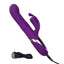 A purple thrusting rabbit vibrator with rotating beads lays flat on a white backdrop with its charging cord attached to the base.