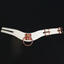 A white faux leather O-ring collar with adjustable dual buckle closures lays flat against a white backdrop.