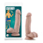 A The Pool Boy Coverboy package stands against a white backdrop with a dildo and balls on it. 