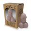 A taupe phallic shaped candle stands next to its package by Little Genie Productions.