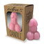 A pink phallic shaped candle stands next to its package by Little Genie Productions.