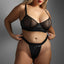 A curvy model wears a mesh bra and crotchless panty with a fetish-fave wet look material in a quilted texture.