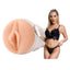 Blake Blossom stands next to a textured vagina masturbator by Fleshlight.