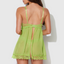 Back view of a model wearing a sheer green chiffon babydoll with an open flyaway rear. 