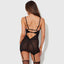 Back view of a model wearing a sheer black sating chemise with detachable garters in the front and back.