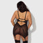 Back view of a curvy model wearing a sheer black sating chemise with detachable garters in the front and back.