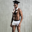 A male model wears a 4 piece graduate costume with a mortarboard hat. 