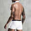 Back view of a male model wearing a 4 piece graduate costume showcasing the white boxer shorts with a black waistband. 