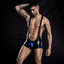A male model wears a wet look black and blue wrestling suit with a blue pouch in the front package.  