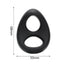 A black silicone dual cock and ball ring stands next to its measurements. 