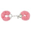 A pair of pink faux fur fluffy handcuffs lays on a white backdrop and showcases its 2 keys. 