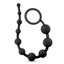 Black silicone anal beads lay flat on a white backdrop with beads graduating in size. 