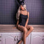 A lifelike 145cm EVO skeleton sex doll sits on a kitchen wearing a black bunny eye mask and leotard showcasing her long blonde hair. 