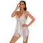 A lingerie model wears a white sheer babydoll with a split-front design and white lace trim on the wire-free cups.