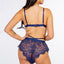 Back view of a model wearing a navy blue lace bralette with French knicker unlined shorts. 