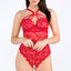 A model wears a red strappy lace crotchless teddy with a floral lace feminine pattern. 