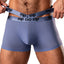 A male model wears a pair of blue briefs with dual slimming waistbands. 