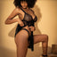 A model wears a black sheer net babydoll with panty that features soft triangular bust cups. 