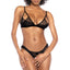 A model wears a black sheer lace lingerie set with floral lace pattern and cutouts around the upper, outer bust. 