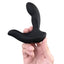 A hand model holds a black vibrating prostate massager featuring a bendable neck. 