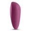 A magenta compact silicone vibrator stands on a white backdrop and showcases its 2 magnetic charging points.