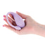 A hand model holds a purple g-spot egg vibrator with an external tail that has a single power button on it. 