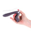 A hand model holds a silicone speculum vibrator with an LED light and ergonomic handle design. 