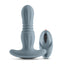 A grey thrusting vibrating anal plug with a rounded tip stands next to its remote. 