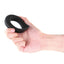 A hand model holds a black textured silicone vibrating cock ring showcasing its scale.