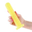 A hand model holds a yellow glow in the dark smooth dildo with a wide suction cup base. 