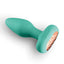 A green app compatible rotating vibrating butt plug lays flat on a white backdrop and showcases its tapered tip.