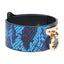 A blue snake print faux leather wrist cuff with O-rings bolted through solid T-plates. 