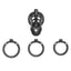 A black lockable cock cage sits next to 3 different sized testicle rings.