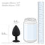 A large black silicone butt plug stands next to a can and ruler for size reference. 