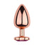 A large rose gold metal butt plug stands against a white backdrop with a tapered tip and bulbous body. 