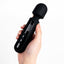 A hand model holds a compact black wand vibrator with LED screen featuring a bulbous head.