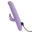 A purple rabbit g-spot stroking vibrator showcases its magnetic charging cord attached to its points on the base handle. 