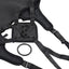 A black strap-on harness lays flat on a white backdrop with snap button closures and 2 O-rings